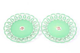 A pair of Spode plates, with reticulated borders, in a green glaze with white detailing,