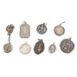 A collection of eight St Christopher pendants, one with a chain. Gross weight: 27.7 grams