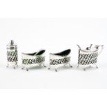 A four piece Edwardian silver, green glass lined cruet set