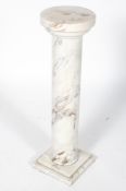 A carrara marble pedestal, of cylindrical form on a square foot,