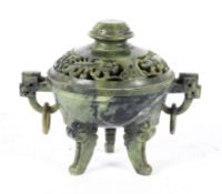 A Chinese spinach soapstone censer, of archaistic tripod form, the cover pierced with dragons,