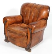 An Art Deco leather armchair, with shell form back,