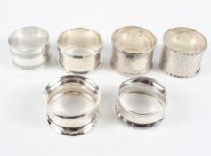 A selection of six assorted silver and white metal napkin rings,