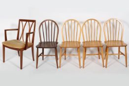 A set of four Ercol stick back dining chairs,