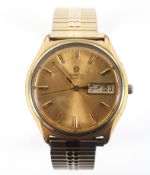 A gold plated Omega quartz wristwatch. Gold circular dial with baton markings and day/date feature.