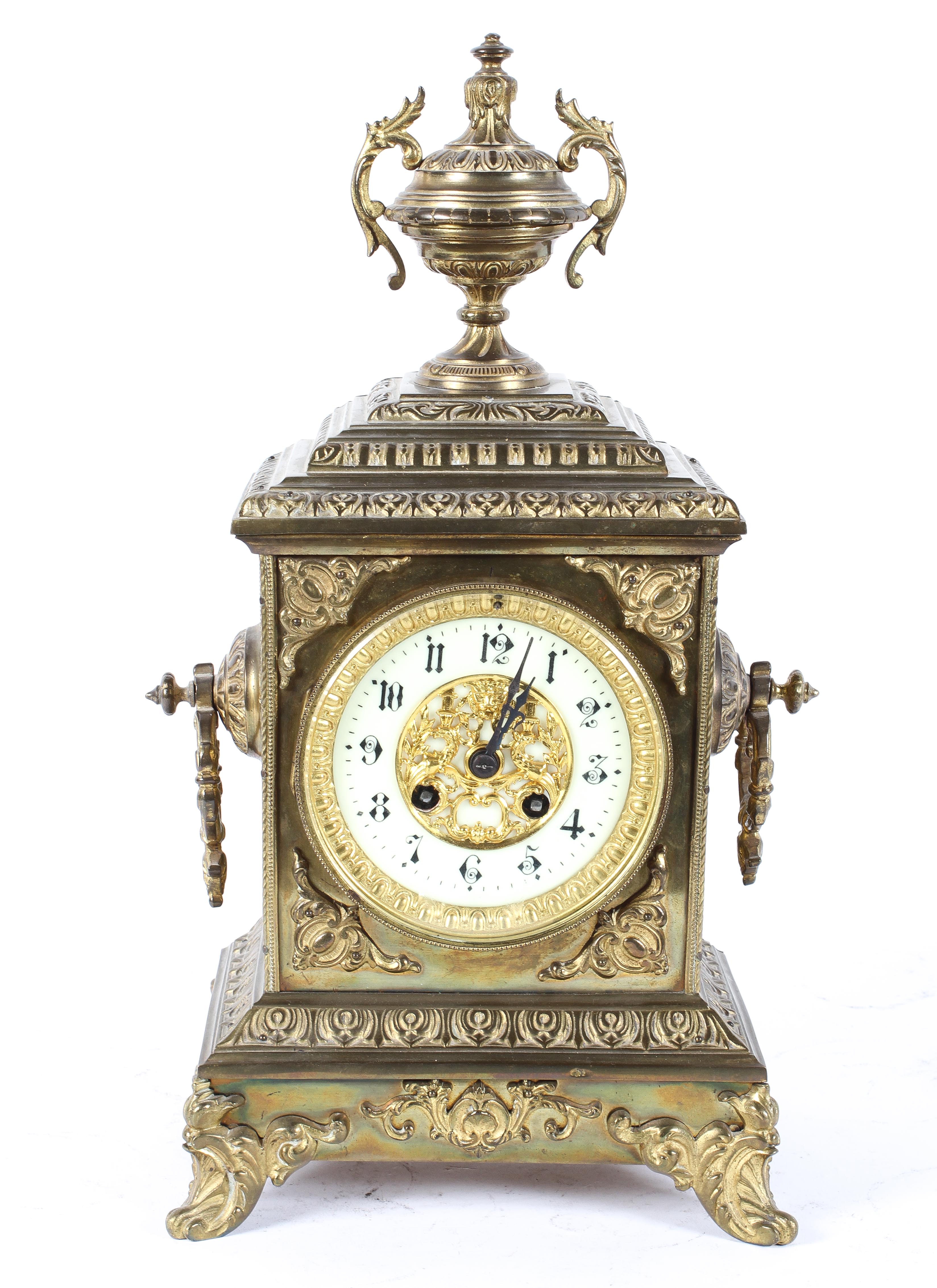 A French gilt brass mantel clock, the 4" ivorine dial with pierced gilt centre,