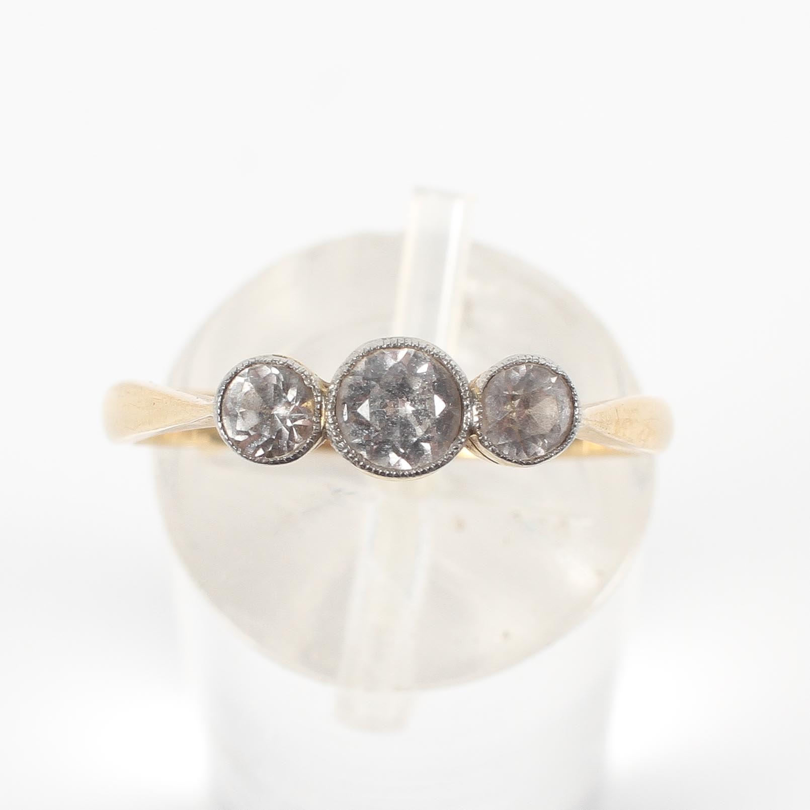A yellow metal three stone ring set with three graduated round cut white stones; - Image 2 of 4