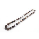 A single strand of graduated banded agate beads.