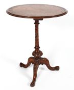 A Victorian Walnut oval occasional table, the inlaid top on a turned column and tripod base,