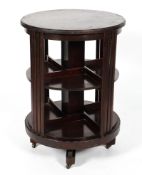 An Edwardian mahogany rotating bookcase of cylindrical form with two tiers on casters,