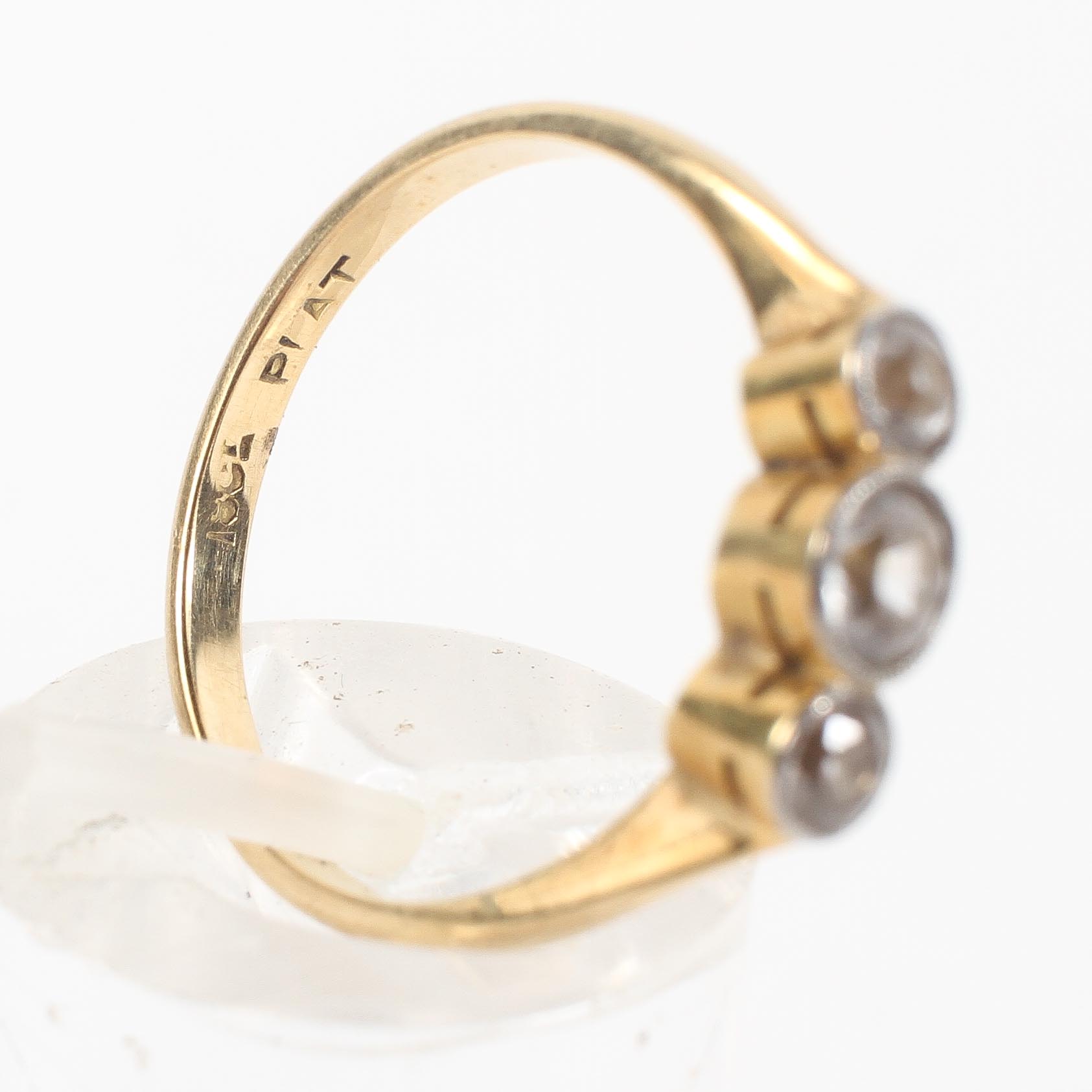 A yellow metal three stone ring set with three graduated round cut white stones; - Image 4 of 4