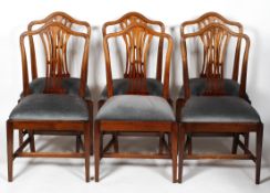 A set of six Hepplewhite style mahogany dining chairs with a pierced,