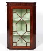 A Regency style mahogany corner cabinet, with astragal glazed doors,