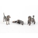 A collection of three silver miniature animal figures to include a poodle, beagle and a fox,