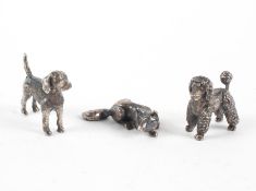 A collection of three silver miniature animal figures to include a poodle, beagle and a fox,