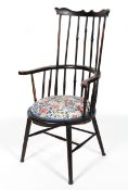 An Arts and Crafts style ebonised comb back Windsor chair,