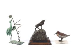A painted spelter figure of a bird on an onyx base,