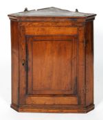 A George III Oak Corner Cabinet, with a panelled door,