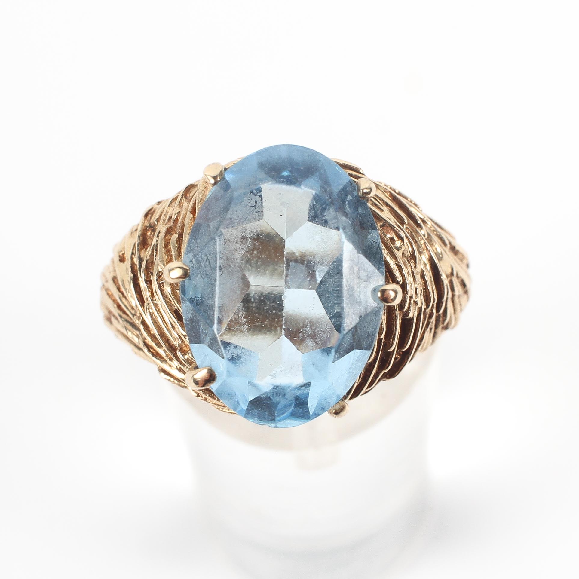 A yellow metal dress ring set with an oval cut blue synthetic spinel. - Image 2 of 4
