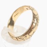 A yellow metal D shape 5mm wedding ring with cherry blossom design (worn) Hallmarked 18ct gold,