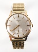 A yellow gold Longines wristwatch. Circular silver dial with baton markings and seconds dial.