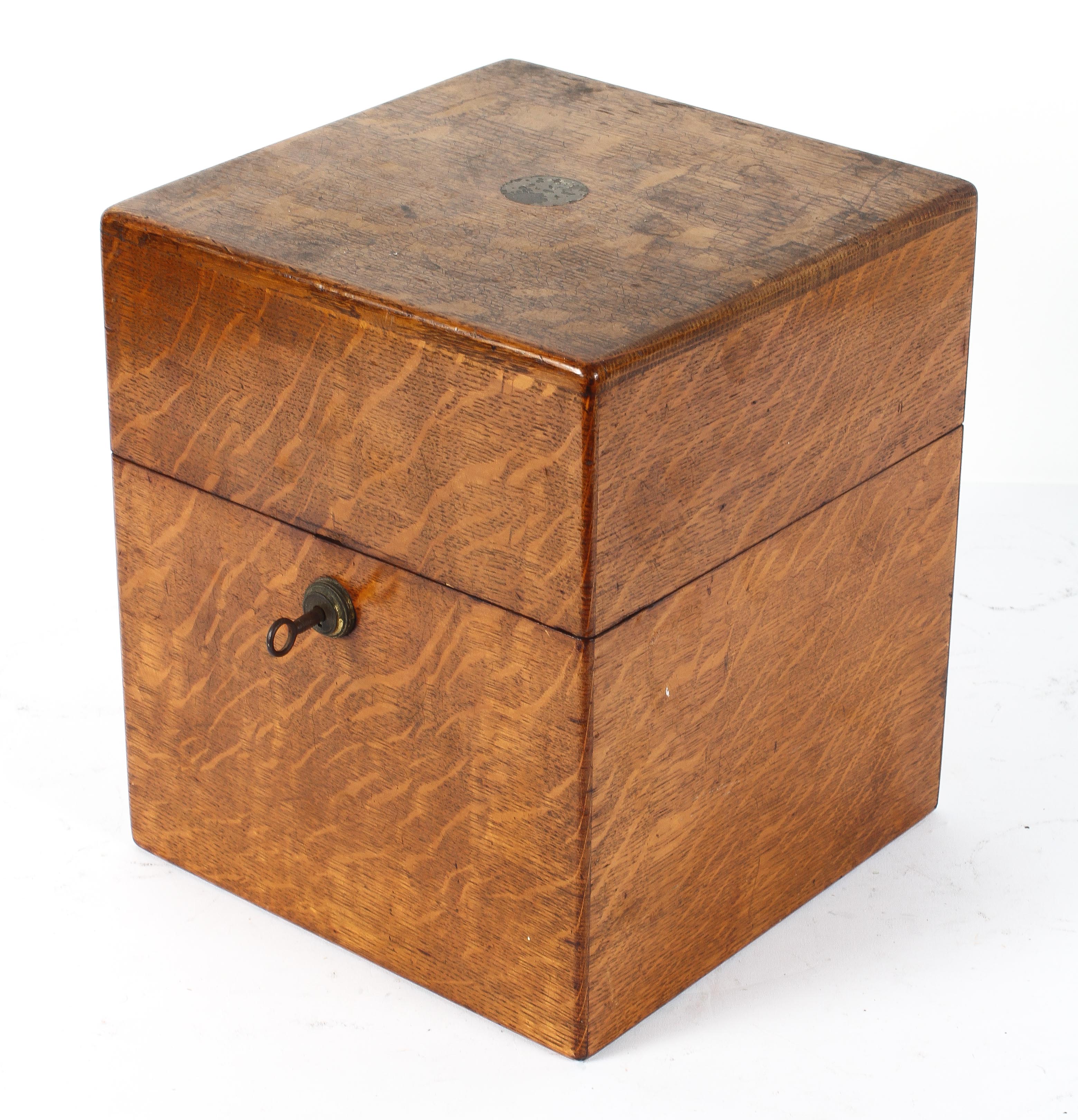 A Victorian oak decanter box, of square section, with four glass decanters and stoppers,
