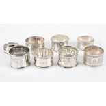 A collection of eight silver napkin rings, including two with engine turned decoration,