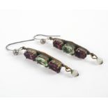 A pair of gold plated drop earrings set with green and purple stones
