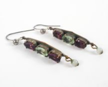 A pair of gold plated drop earrings set with green and purple stones