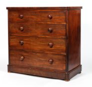 A Victorian mahogany chest of three graduated long drawers with turned pulls,