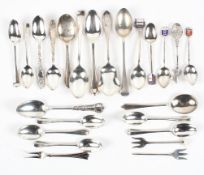 A collection of silver spoons and similar silver items, including examples with enamel finials,