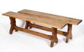 A pair of pine benches, with shaped legs, 49cm high x 153cm long x 27.