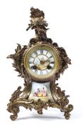 A French mantel clock, the painted porcelain dial on a brass, eight day movement striking to a bell,