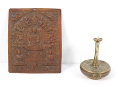 A Buddhistic copper plaque, with three deities surrounded by other figures and beasts,