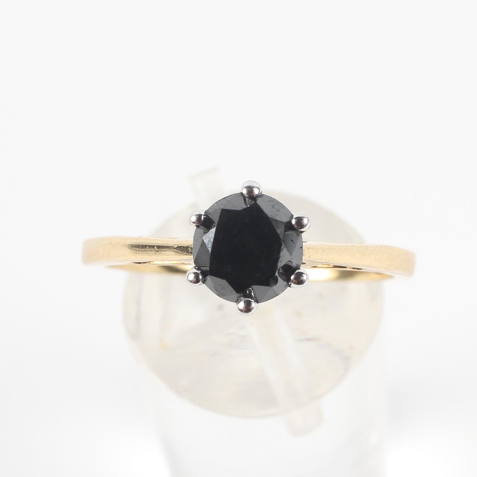 A yellow and white metal ring set with a round faceted cut black diamond estimated to weigh 1.14cts. - Image 2 of 3