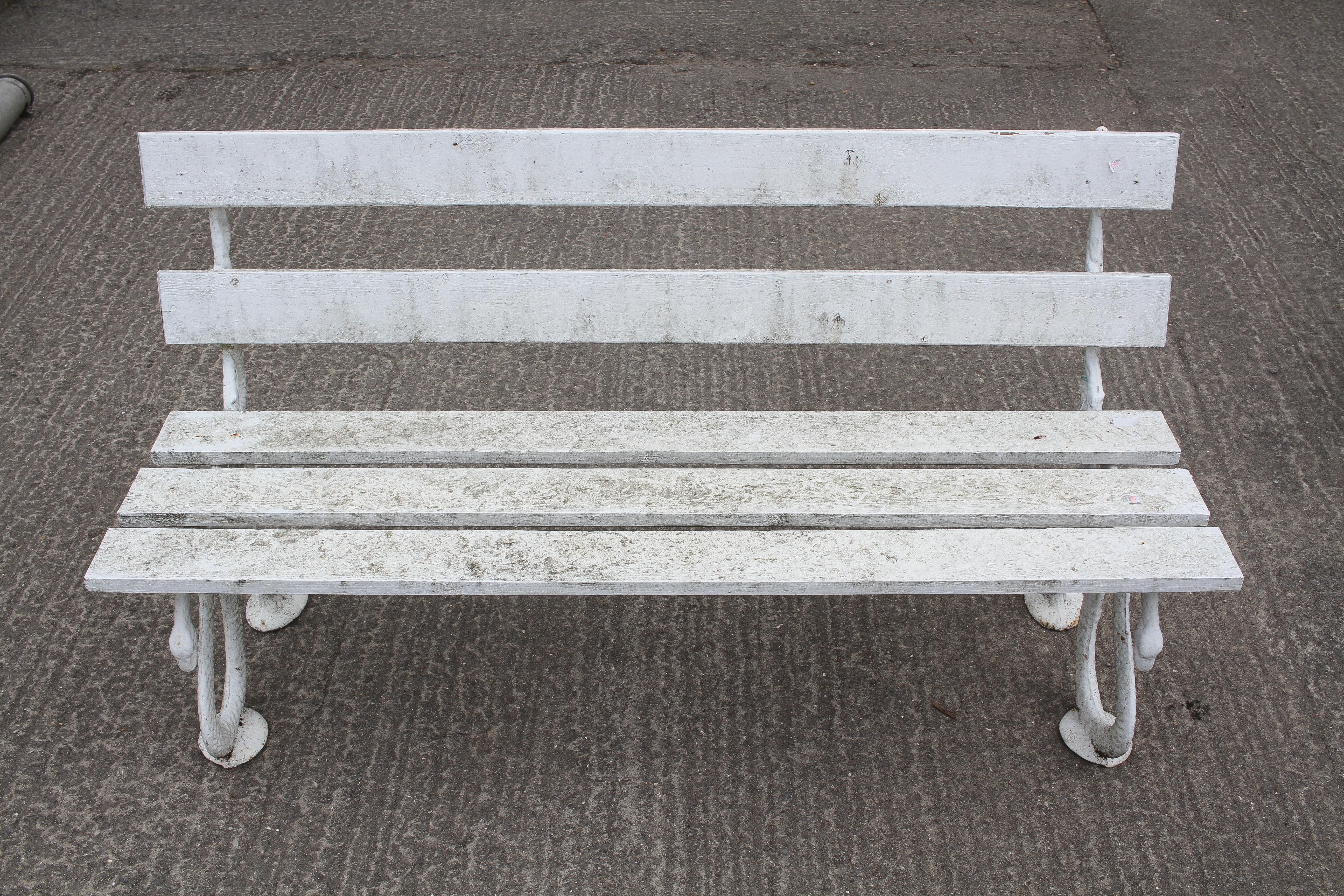 A Coalbrookdale style cast iron and wooden slatted bench, with snake and branch supports,