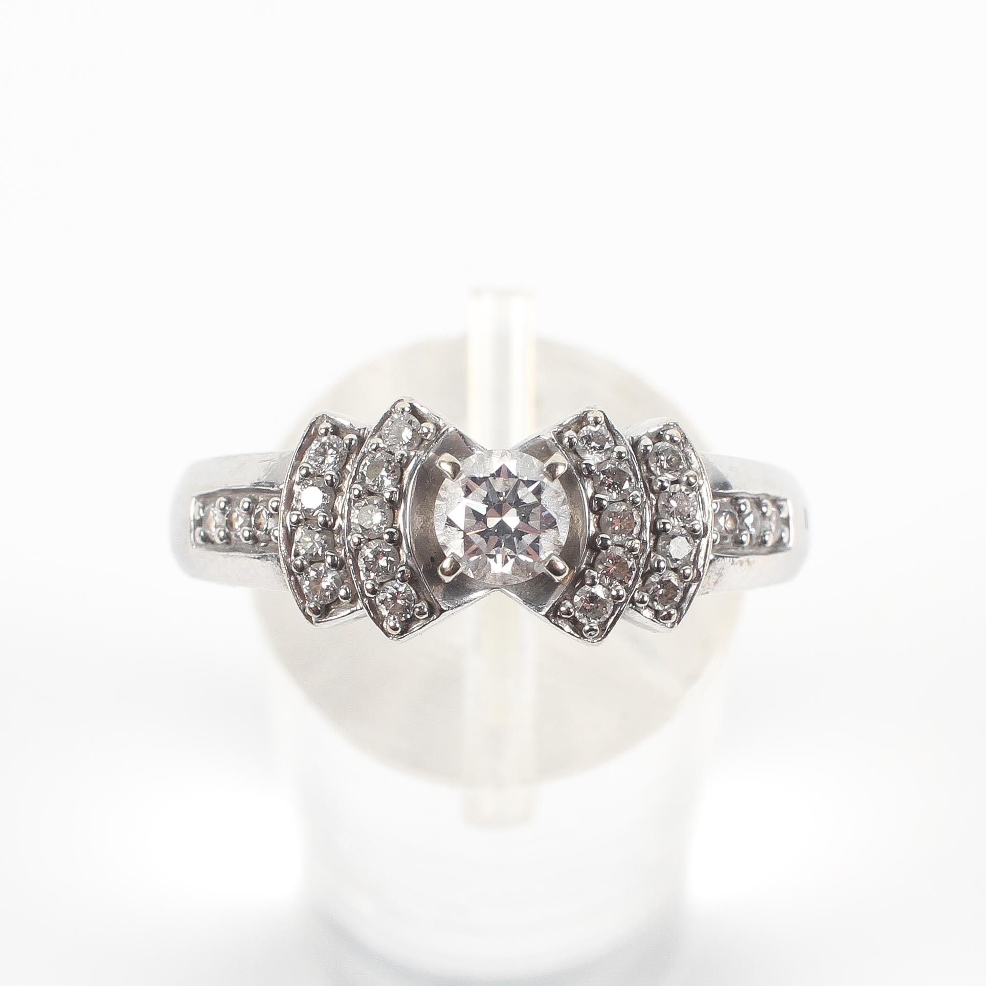 A white metal ring principally set with a round brilliant cut diamond estimated to weigh 0.25cts. - Image 2 of 3