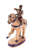 A Hispano Moresque stoneware horse and rider, 19th century, in copper lustre with blue highlights,