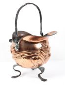 An Arts and Craft style copper coal skuttle, of helmet-shape, cast with scrolling tendrils,
