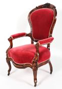 A Victorian walnut velvet upholstered armchair, of serpentine form,