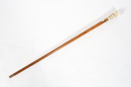 A Victorian ivory and gold mounted malacca walking cane, the pommel carved with a stag hunt,