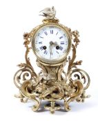 A French gilt metal mantel clock, the 3 3/4" enamelled dial on a brass,