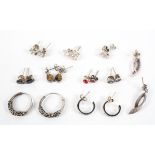 A collection of ten pairs of silver earrings of variable designs.