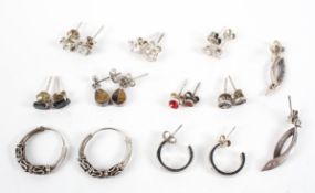 A collection of ten pairs of silver earrings of variable designs.