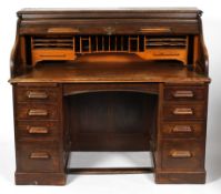 An oak tambour fronted bureau, with fitted interior above two runs of four drawers,