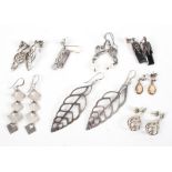 A collection of eight pairs of silver earrings of variable designs. Gross weight: 34.4 grams