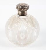 An Edwardian silver mounted cut glass scent bottle of globular form,