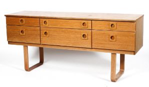 A Schreiber teak dressing table and mirror, with an arrangement of six drawers with circular pulls,