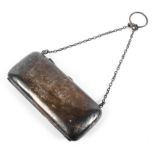 A late Edwardian silver purse with engraved decoration to one side, oblong form,