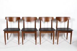 A set of four vintage teak dining chairs, with black leatherette seats,
